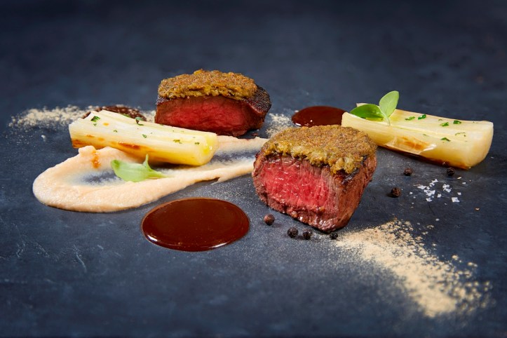 Black Angus beef tenderloin gratinated with liquorice and capers celery root puree leeks_credits solostepstudio